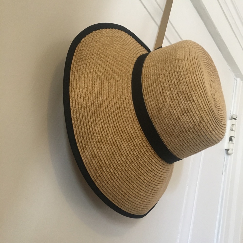 Woven hat with black ribbon